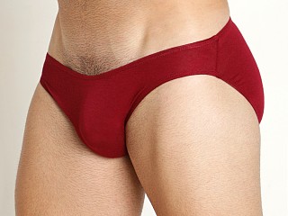 Model in maroon Mckillop Hustle Sliver Whisper Seamless Front Brief