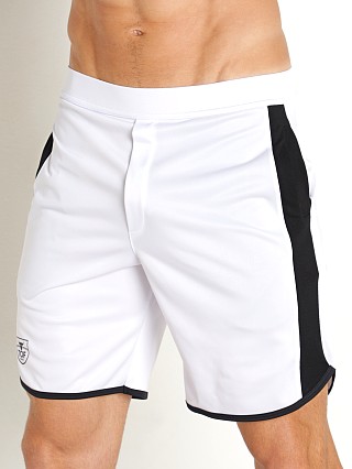 Model in white TOF Paris Gym Long Shorts