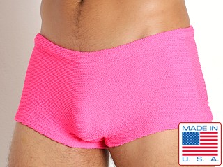 Model in neon pink Rick Majors Ripple Nylon Low Rise Swim Trunk