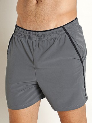 Model in pitch gray Under Armour Qualifier 5" Performance Shorts