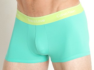 Model in aqua green Calvin Klein Pride Micro Low Rise Trunk