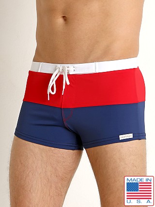 Model in navy/red/white Sauvage Fitted Square Cut Swim Trunk