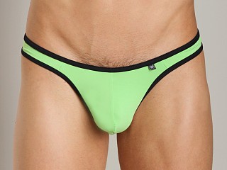 Model in green Tulio Sling C-Enhancer Slinky Thong