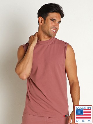 Model in red clay Go Softwear Zion OverDye Raw Edge Muscle Shirt