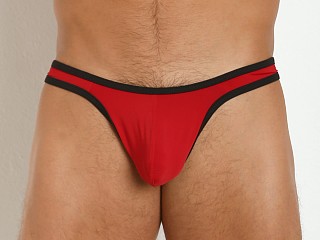 Model in red/black Tulio Sling C-Enhancer Slinky Thong