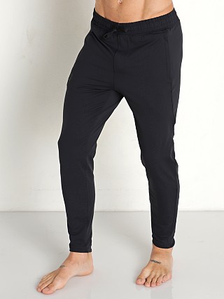 Model in black Under Armour Meridian Tapered Pants