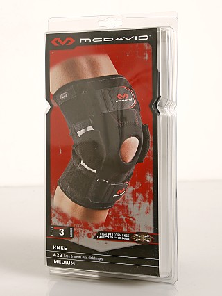 Model in black McDavid Sports Medicine Knee Brace with Disk Hinges