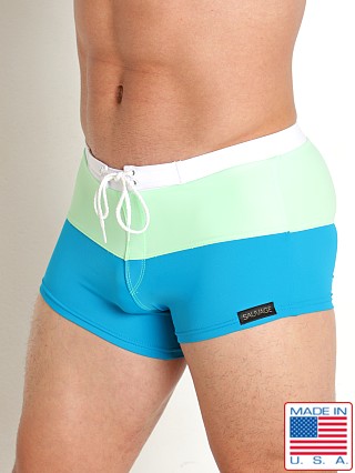 Model in teal/pistachio Sauvage Splice Square Cut Swim Trunk