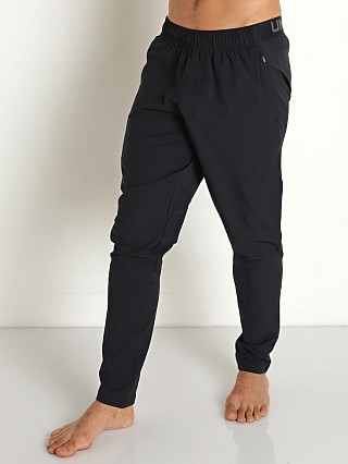 Model in black/pitch gray Under Armour Ripstop Woven Pants