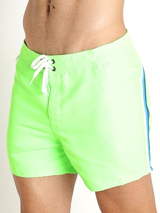 Model in fluorescent green Sundek 14" Classic Low-Rise Boardshort