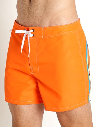 Model in papaya orange Sundek 14" Classic Low-Rise Boardshort