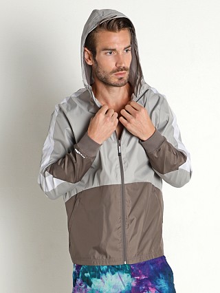 Model in fresh clay/tin-white Under Armour Legacy Windbreaker Jacket