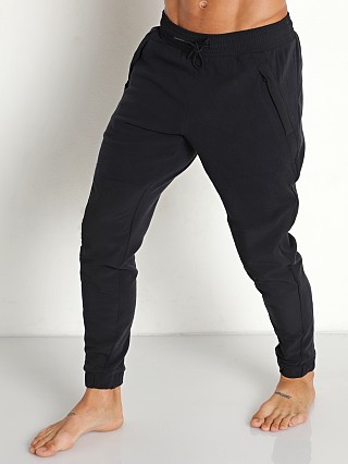 Model in black/black Under Armour Rush Fleece Pants