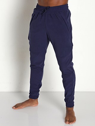 Model in midnight navy/brilliance Under Armour Rush Fleece Pants