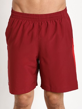 Model in cardinal/red Under Armour Launch 7" Solid Short