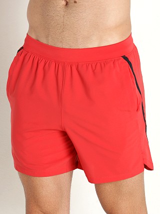 Model in chakra orange Under Armour Launch 5" Running Short