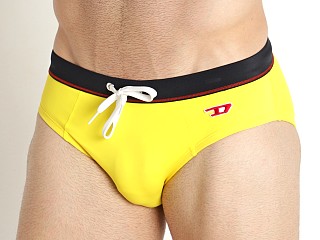 Model in yellow Diesel Alfie Swim Brief