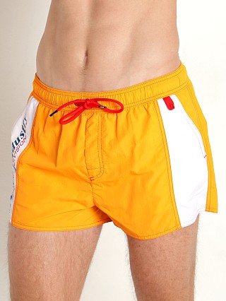 Model in mandarin Diesel Caybay Swim Shorts