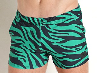 Model in green Modus Vivendi Tiger Swim Shorts