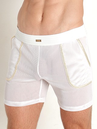 Model in white STUD Trax Mesh Shorts