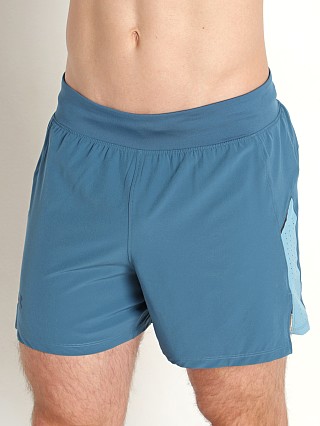 Model in static blue/reflective Under Armour Launch Elite 5'' Short