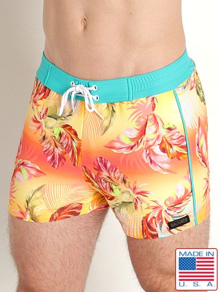 Model in tropical floral Sauvage Italian Lycra Printed Swim Trunk