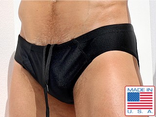 Model in shiny black Rufskin Ciro Mini-Sunga Swim Brief