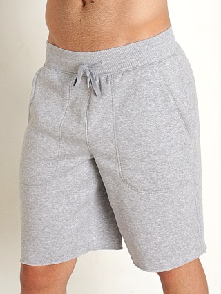 Model in true gray heather Under Armour Hustle Fleece Shorts