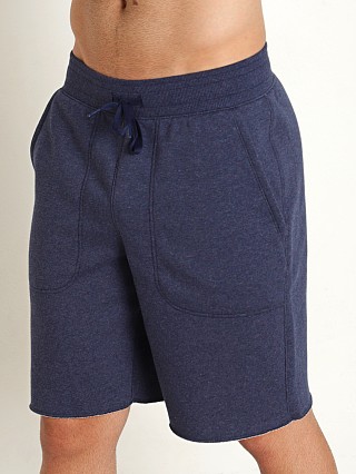 Model in midnight navy heather Under ArmourHustle Fleece Shorts