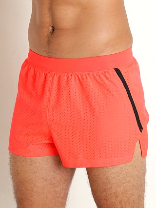 Model in beta orange/reflective Under Armour Launch Split Performance Short Beta Orange