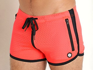 Model in neon orange Breedwell Exposer Circuit Shorts