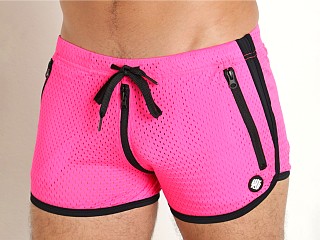 Model in neon pink Breedwell Exposer Circuit Shorts