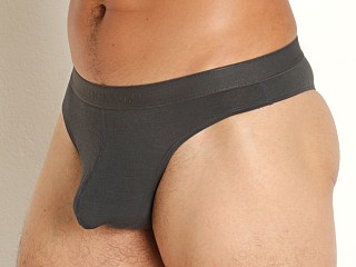 Model in charcoal grey Cocksox Natural Origins Enhancer Thong