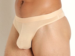 Model in sandstone Cocksox Natural Origins Enhancer Thong